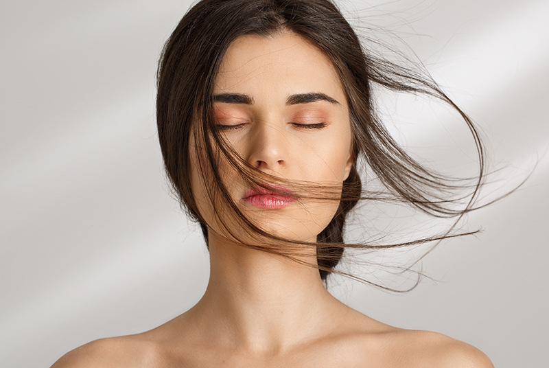 dark-haired woman with closed eyes